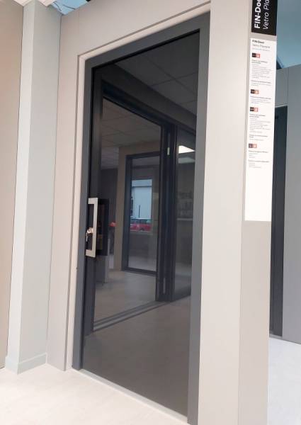 Porte d'entrée en PVC capoté aluminium avec un panneau en vitrage émaillé visible à notre agence de Meyzieu proche de Lyon